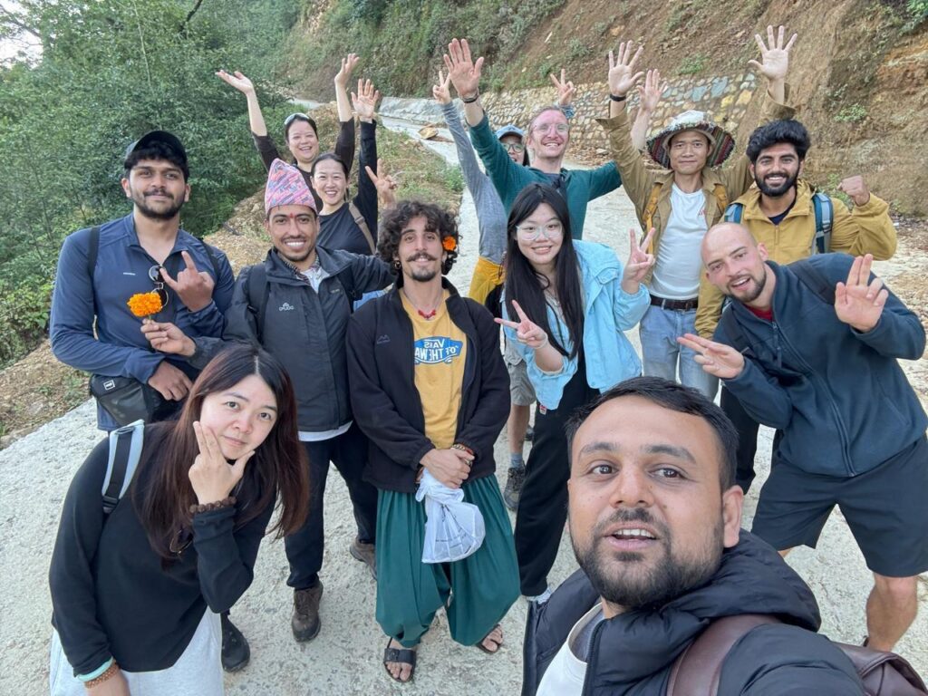 Hikers crossing a forest trail during a wellness day hike near Kathmandu.